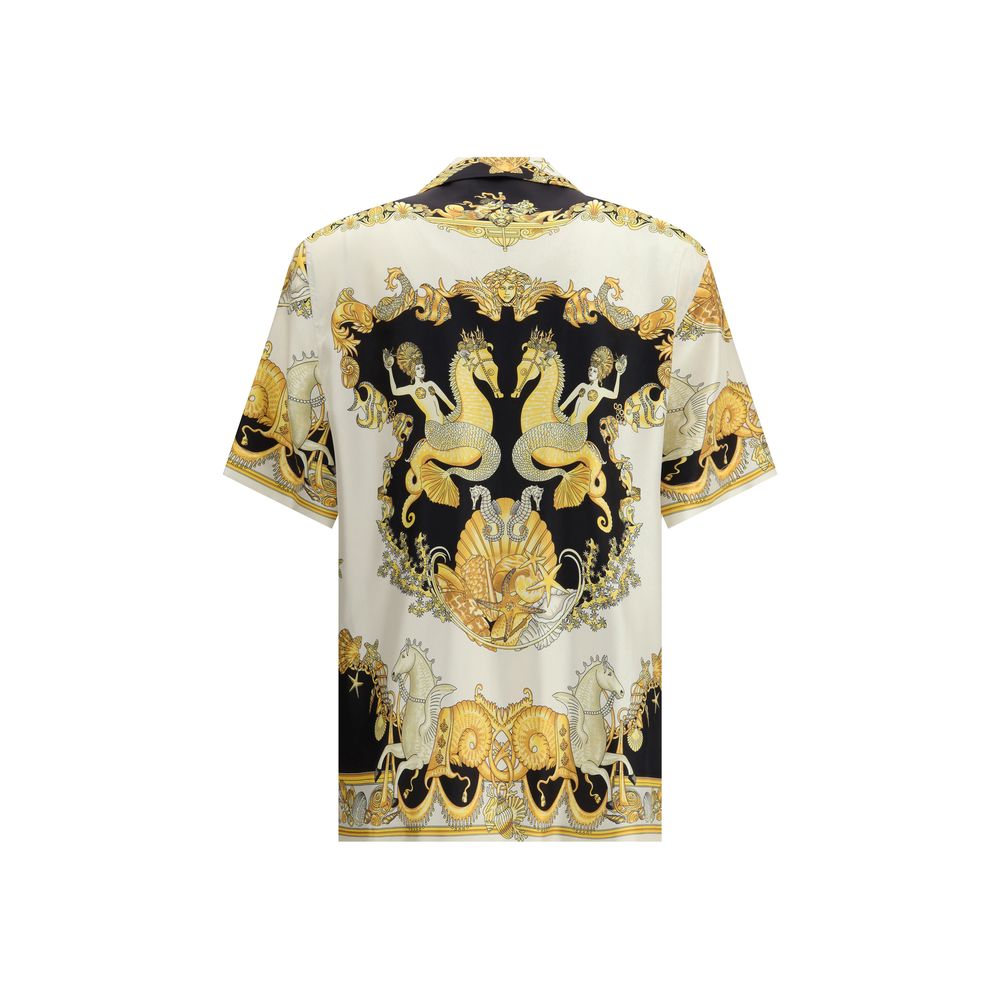Multicolor Silk Shortsleeve ShirtVersace’s silk Theatre Shirt is a short-sleeved design with a Cuban collar and front button closure. The exclusive print depicts corals, shells and mermaids, enhanced by theatrical elements that express the Maison’s deep c