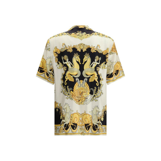 Multicolor Silk Shortsleeve ShirtVersace’s silk Theatre Shirt is a short-sleeved design with a Cuban collar and front button closure. The exclusive print depicts corals, shells and mermaids, enhanced by theatrical elements that express the Maison’s deep c