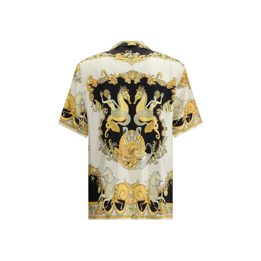 Multicolor Silk Shortsleeve ShirtVersace’s silk Theatre Shirt is a short-sleeved design with a Cuban collar and front button closure. The exclusive print depicts corals, shells and mermaids, enhanced by theatrical elements that express the Maison’s deep c