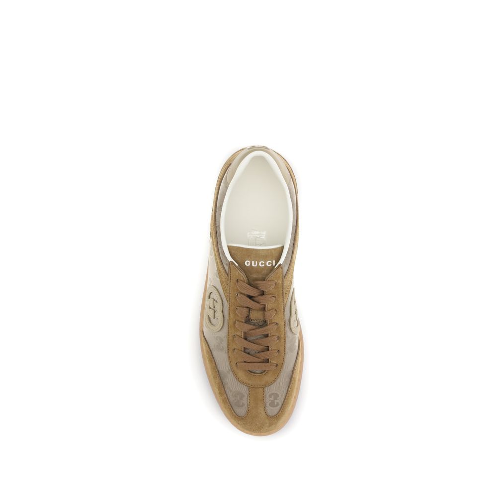 Beige Leather Athletic SneakersGucci’s G75 Sneakers reinterpret the retro sports aesthetic with premium materials and iconic details. Made of gray suede with GG nylon inserts, they feature a low-slung silhouette and a classic lace-up closure. The leather