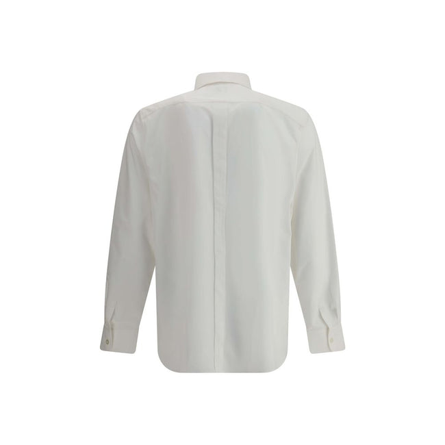 White Cotton Dress ShirtSaint Laurent’s cotton Shirt is a clean and elegant design. Made of cotton poplin, it features a classic collar, a front closure with concealed buttons for a minimal and neat effect, and a discreet but distinctive embroidered logo