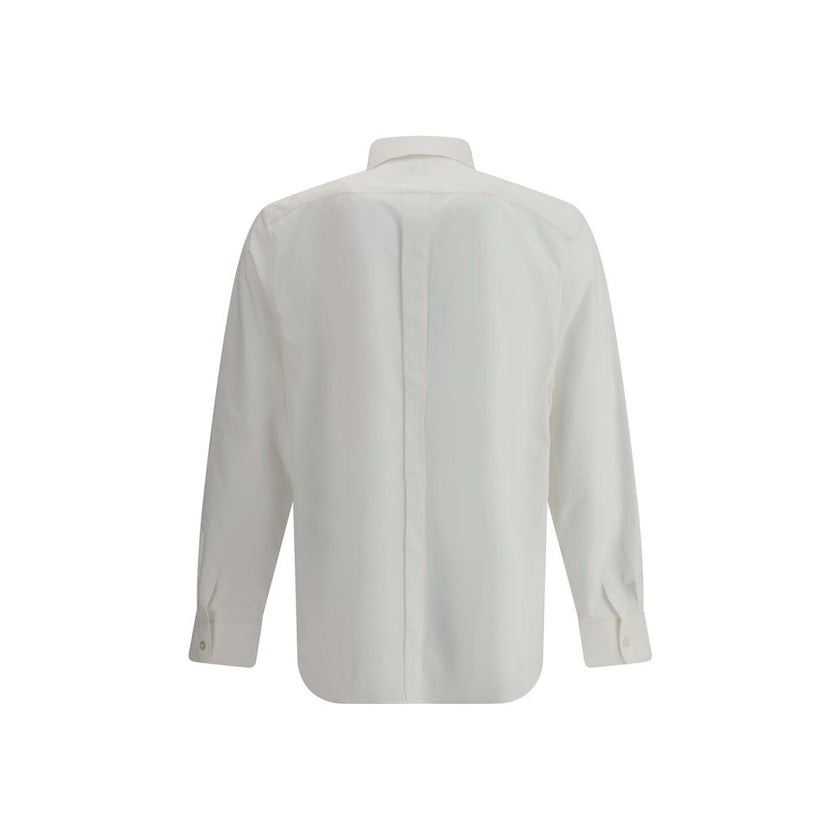 White Cotton Dress ShirtSaint Laurent’s cotton Shirt is a clean and elegant design. Made of cotton poplin, it features a classic collar, a front closure with concealed buttons for a minimal and neat effect, and a discreet but distinctive embroidered logo