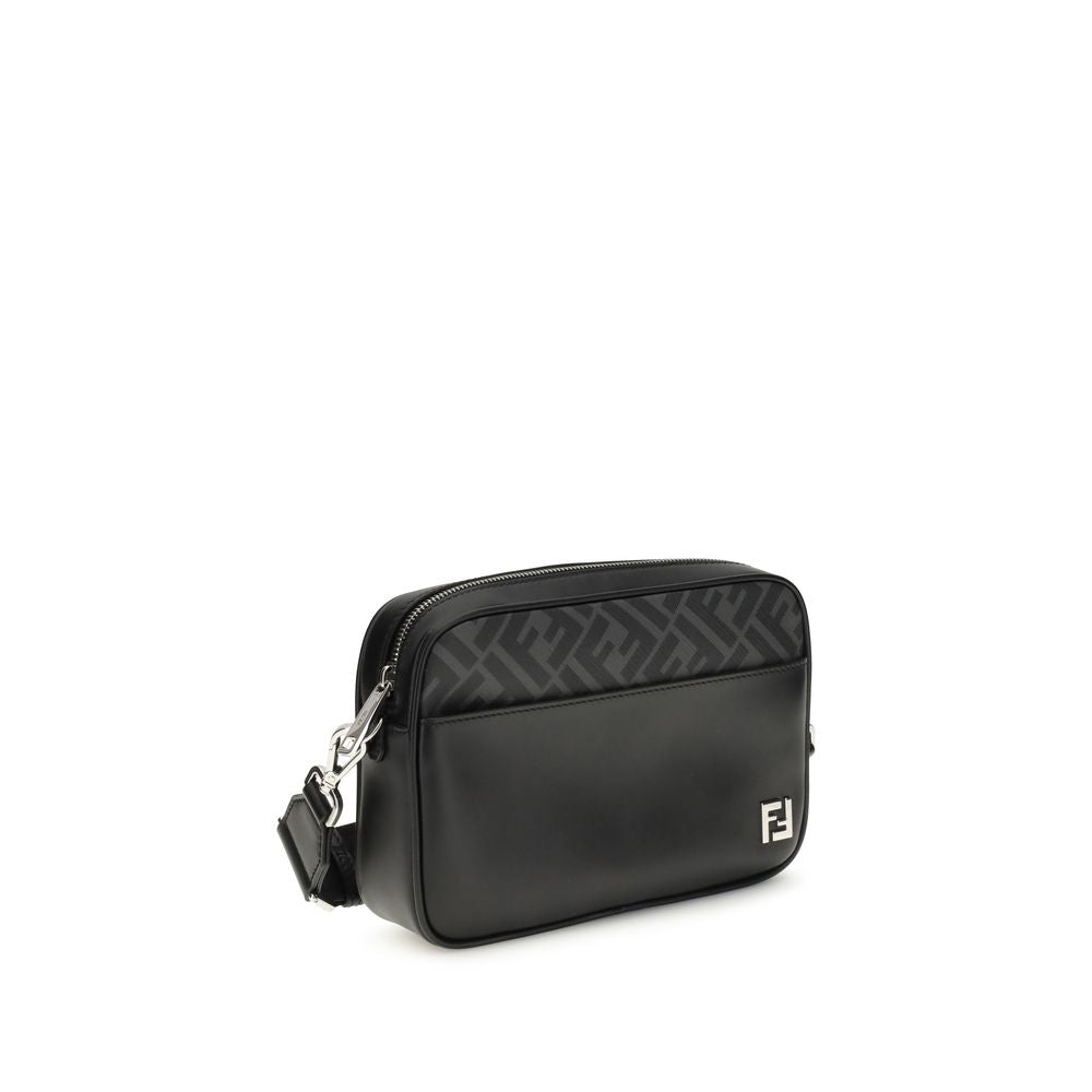 Black Leather Shoulder BagFendi’s FF leather and canvas Shoulder Bag is a compact model that combines elegance and functionality. Made of smooth black leather and FF Canvas in the same color, it is embellished with a metal FF logo applique. It features an