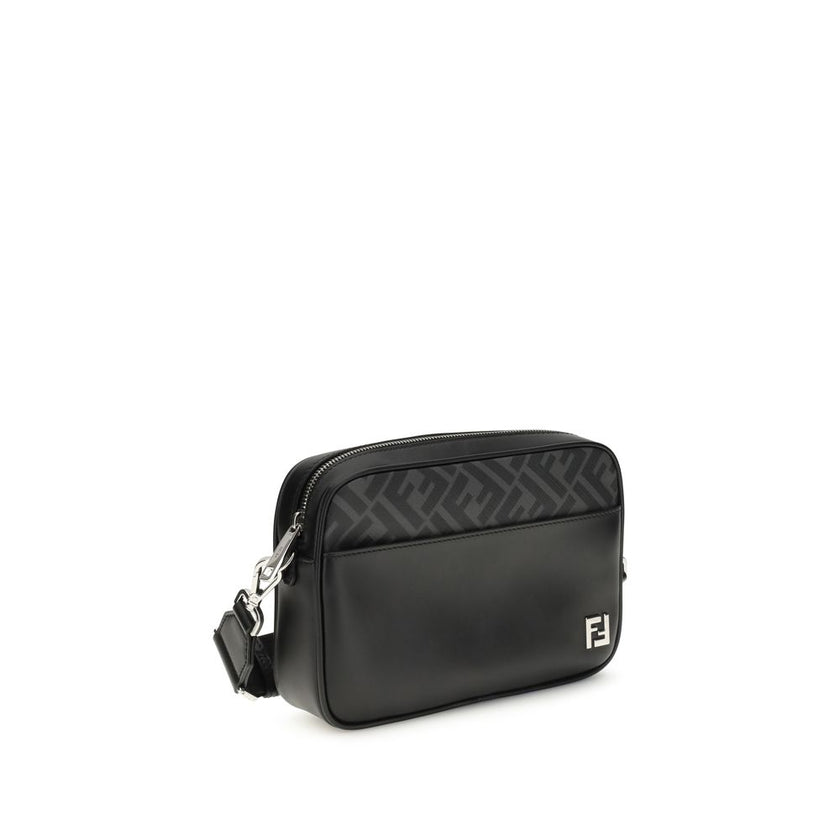 Black Leather Shoulder BagFendi’s FF leather and canvas Shoulder Bag is a compact model that combines elegance and functionality. Made of smooth black leather and FF Canvas in the same color, it is embellished with a metal FF logo applique. It features an