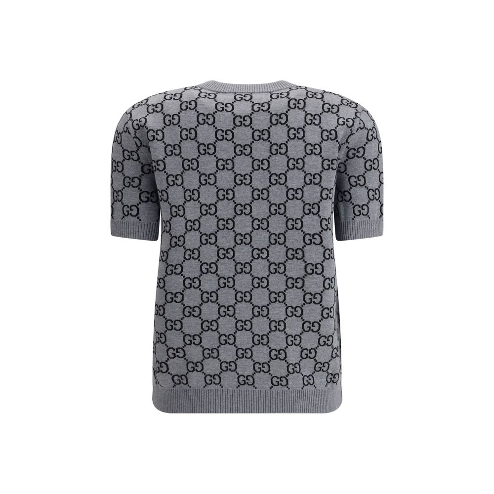 Gray Wool SweatshirtGucci’s short-sleeve Sweater is a retro-inspired piece that celebrates the house’s iconic aesthetic. Crafted in the unmistakable GG Supreme pattern, it features a ribbed crew neck and ribbed trim at the hem as well, defining the line w