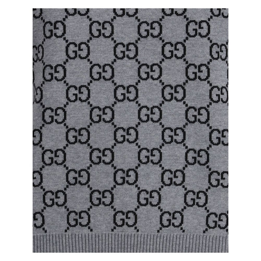 Gray Wool SweatshirtGucci’s short-sleeve Sweater is a retro-inspired piece that celebrates the house’s iconic aesthetic. Crafted in the unmistakable GG Supreme pattern, it features a ribbed crew neck and ribbed trim at the hem as well, defining the line w