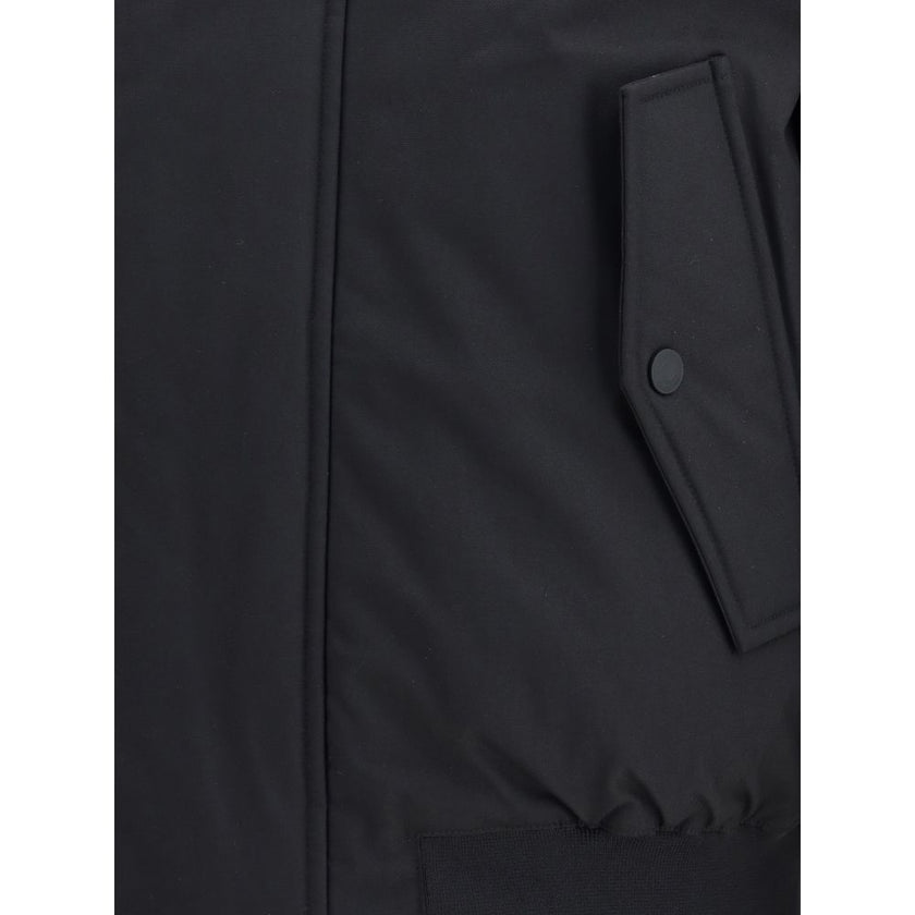 Black Polyester BomberThe Sport short Down Jacket by Dsquared2 is a padded garment with a functional and urban design. Featuring a hood and concealed front zipper and button closure, it has a ribbed elastic hem and cuffs for a comfortable fit. Two front w