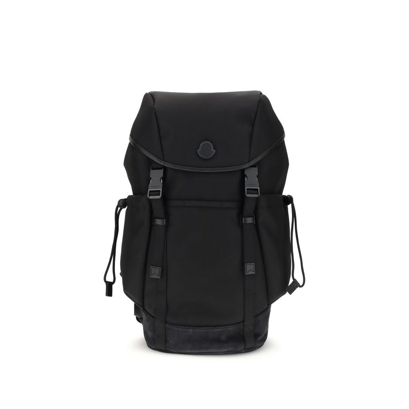 Tech BackpackMoncler’s tech Backpack combines functionality and style in a modern, practical design. Featuring a front flap closure and two snap buckles, it offers security and ease of use. The logo on the front lends a distinctive touch, while adjustable