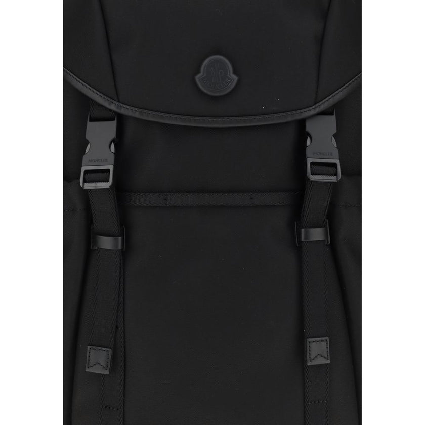 Tech BackpackMoncler’s tech Backpack combines functionality and style in a modern, practical design. Featuring a front flap closure and two snap buckles, it offers security and ease of use. The logo on the front lends a distinctive touch, while adjustable