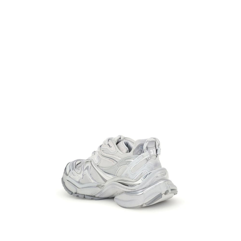 Silver Rubber Athletic SneakersBalenciaga’s Runner 2.0 Sneakers stand out for their worn-in effect, recalling a grunge and lived-in aesthetic typical of the brand. They feature the size printed on the toe and embossed on the back, along with the “Runner”
