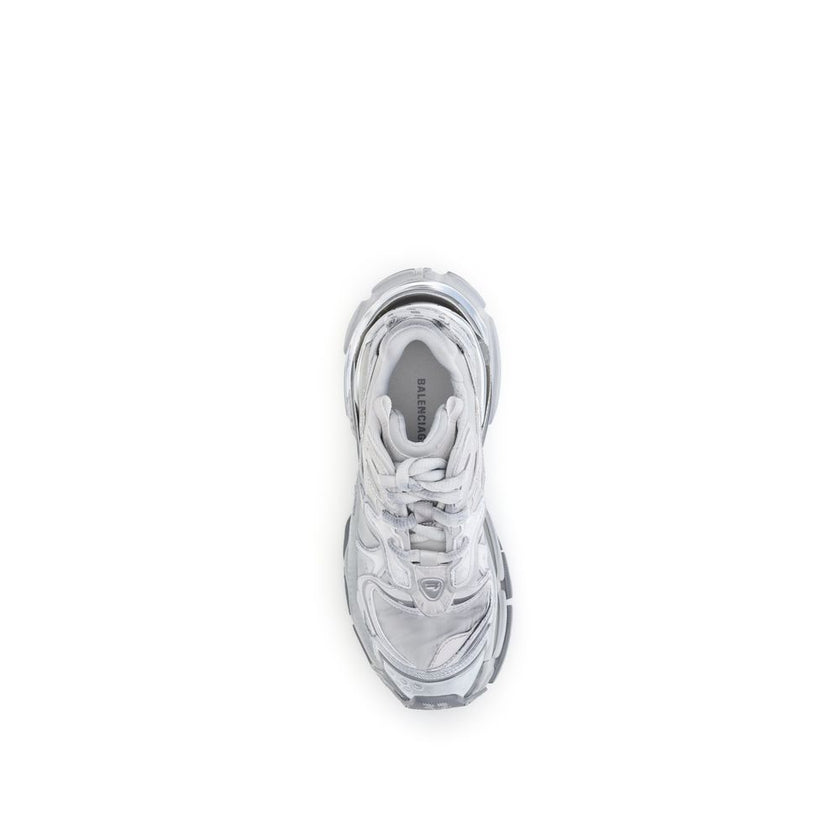 Silver Rubber Athletic SneakersBalenciaga’s Runner 2.0 Sneakers stand out for their worn-in effect, recalling a grunge and lived-in aesthetic typical of the brand. They feature the size printed on the toe and embossed on the back, along with the “Runner”