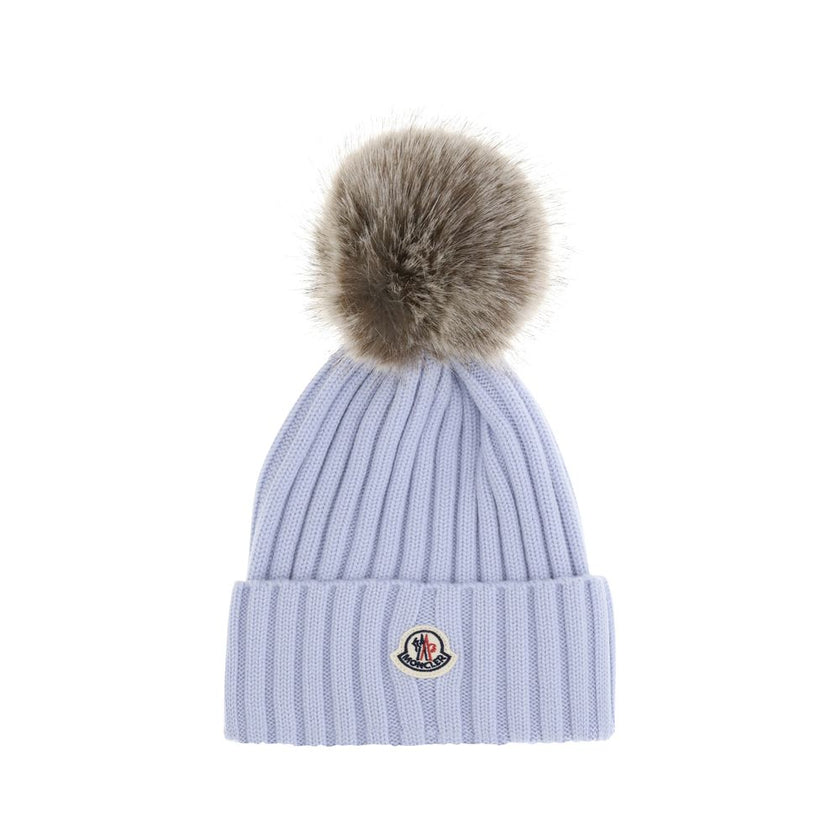 Pom pom wool HatThe Wool Hat by Moncler is the ideal accessory to complete winter looks. Made from extra fine Merino wool yarn, it features a ribbed knit that enhances its quality and softness. The design is embellished with a pom-pom made of synthetic ma