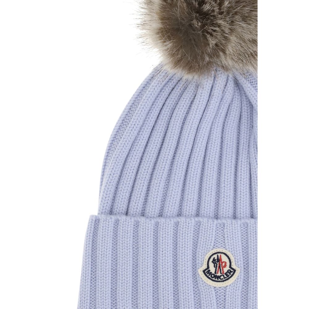 Pom pom wool HatThe Wool Hat by Moncler is the ideal accessory to complete winter looks. Made from extra fine Merino wool yarn, it features a ribbed knit that enhances its quality and softness. The design is embellished with a pom-pom made of synthetic ma