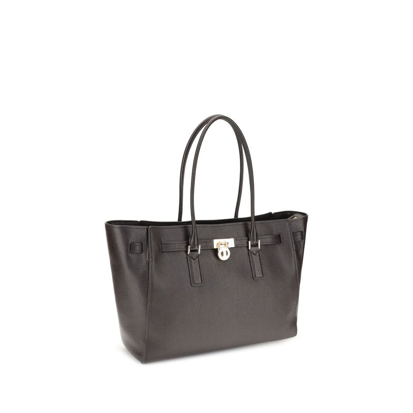 Brown Calf Leather Bos Taurus Shoulder BagThe Hamilton Moderne large Tote Bag by Michael Kors is a roomy, structured model designed to combine functionality and elegance. The silhouette with decorative belt and iconic padlock pendant define its sophistica