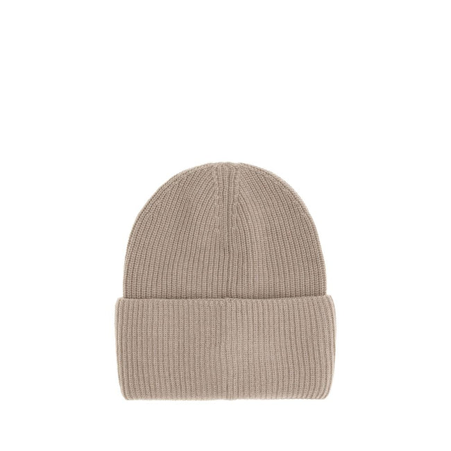 Beige Wool BeanieThe beanie hat by Moncler is a versatile wool accessory with a classic cut, perfect for both city days and outdoor adventures. Designed to provide warmth and comfort, this knitted hat is made from high-quality carded wool. The medium-weig