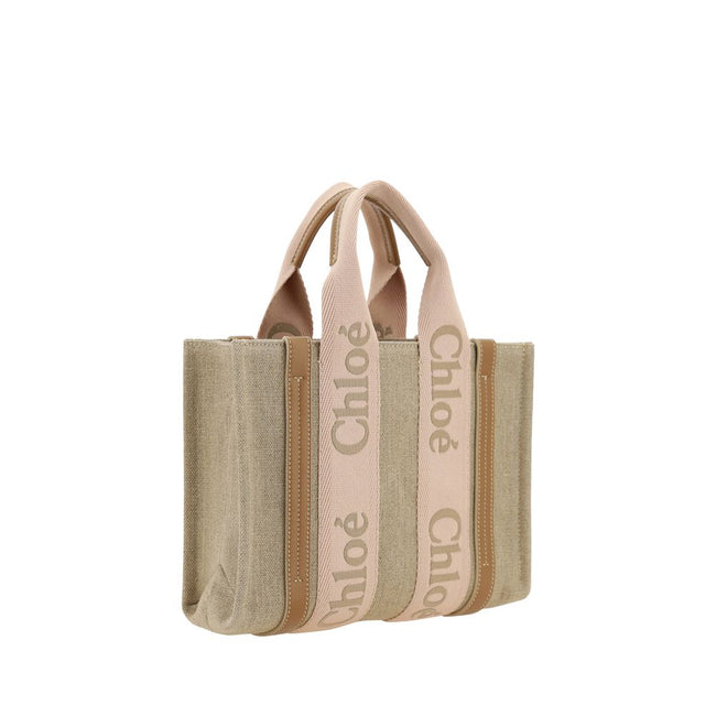 Beige Linen HandbagChloé’s Woody Handbag is an elegant and practical accessory made of linen and detailed with contrasting leather. The concealed button top closure maintains a clean design, while the double flat handles and extension on the leather side