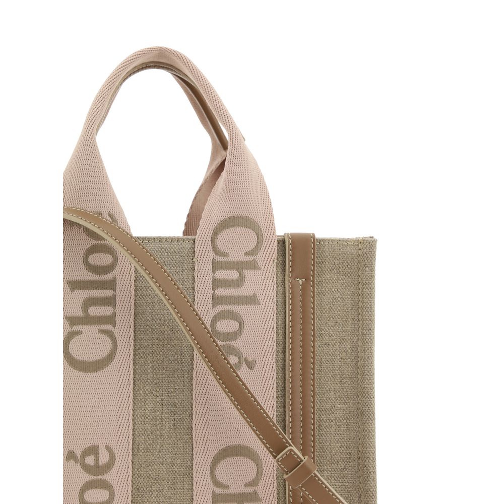 Beige Linen HandbagChloé’s Woody Handbag is an elegant and practical accessory made of linen and detailed with contrasting leather. The concealed button top closure maintains a clean design, while the double flat handles and extension on the leather side