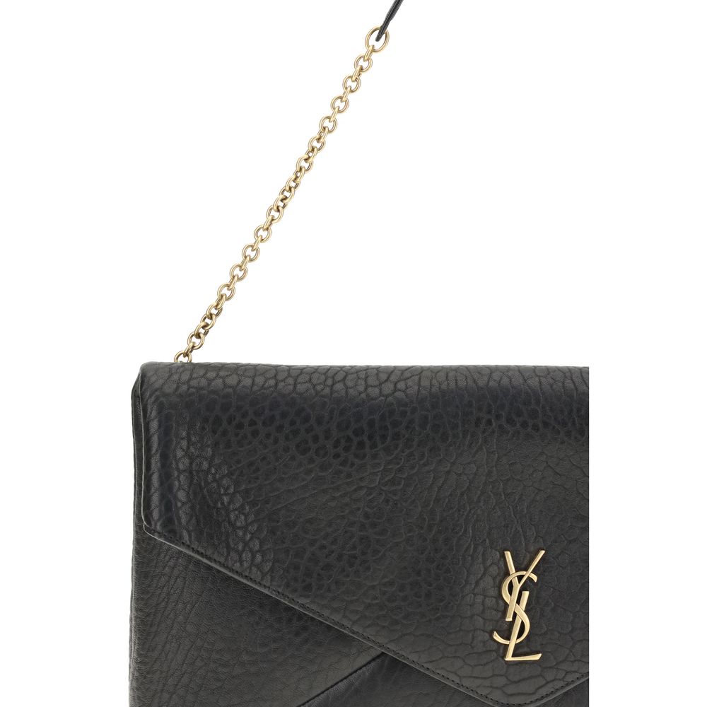 Black Lamb Ovis Aries Aries Shoulder BagThe Cassandre XXL Shoulder Bag with Chain by Saint Laurent is an extra-large clutch made of soft lambskin leather, embellished with the iconic metal Cassandre logo. Equipped with a stowable cable chain strap, it can