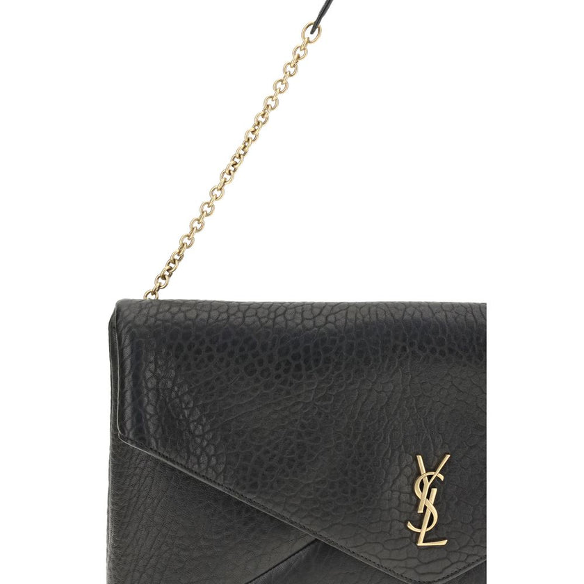 Black Lamb Ovis Aries Aries Shoulder BagThe Cassandre XXL Shoulder Bag with Chain by Saint Laurent is an extra-large clutch made of soft lambskin leather, embellished with the iconic metal Cassandre logo. Equipped with a stowable cable chain strap, it can