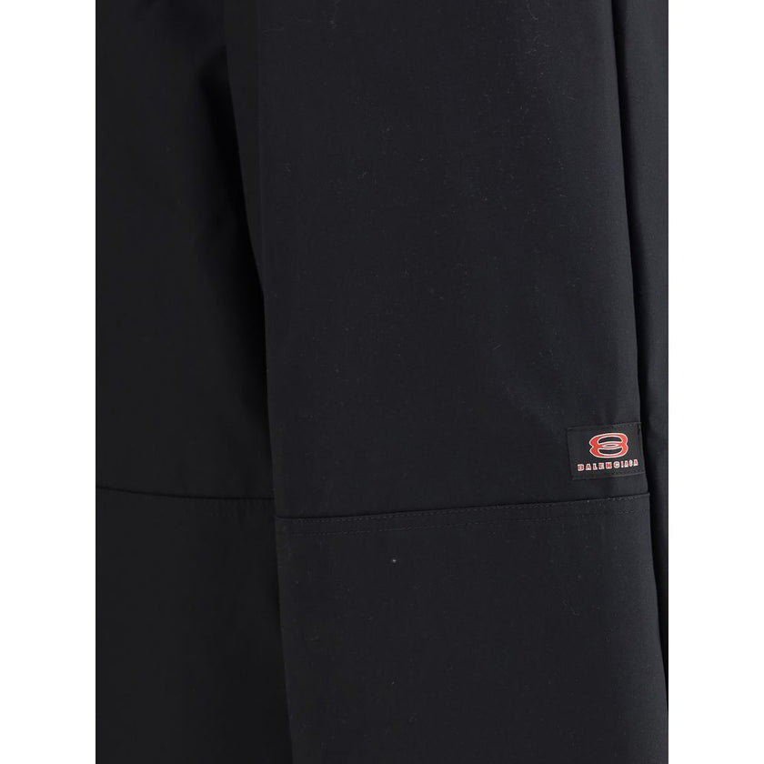 Black Cotton Casual PantsBalenciaga’s Utility Workwear Pants reinterpret workwear style with a contemporary twist. Made of durable cotton twill, they feature a hidden zipper flap, seven belt loops at the waist, two slit pockets at the front and two welt p