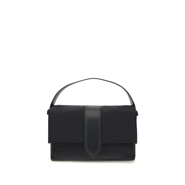 Black Nylon Shoulder BagThe Bambino Shoulder Bag by Jacquemus reinterprets the messenger style with a practical, contemporary design. Made of padded nylon, it features a leather handle and magnetic flap with tab, combined with a zipper closure for added s