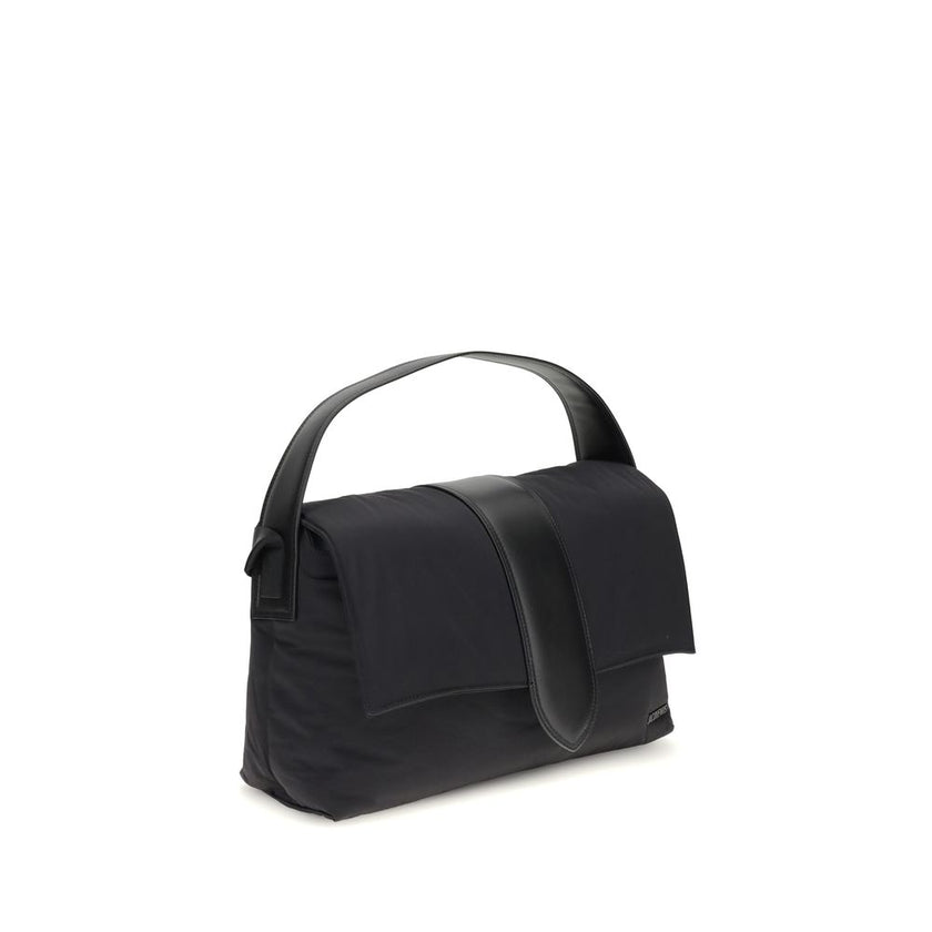 Black Nylon Shoulder BagThe Bambino Shoulder Bag by Jacquemus reinterprets the messenger style with a practical, contemporary design. Made of padded nylon, it features a leather handle and magnetic flap with tab, combined with a zipper closure for added s