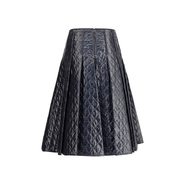 Black Polyamide Midi SkirtMoncler’s padded midi Skirt combines style and functionality in a unique design. Made of iconic laqué nylon with matching lining, it features lightweight padding for thermal comfort. Pleating lends movement and femininity, while