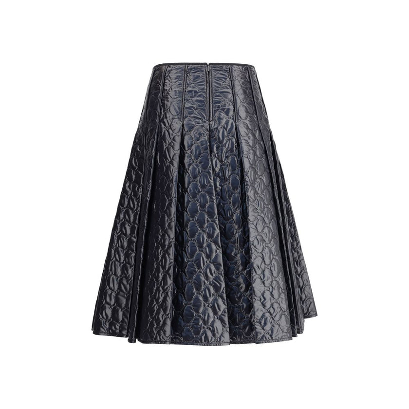 Black Polyamide Midi SkirtMoncler’s padded midi Skirt combines style and functionality in a unique design. Made of iconic laqué nylon with matching lining, it features lightweight padding for thermal comfort. Pleating lends movement and femininity, while