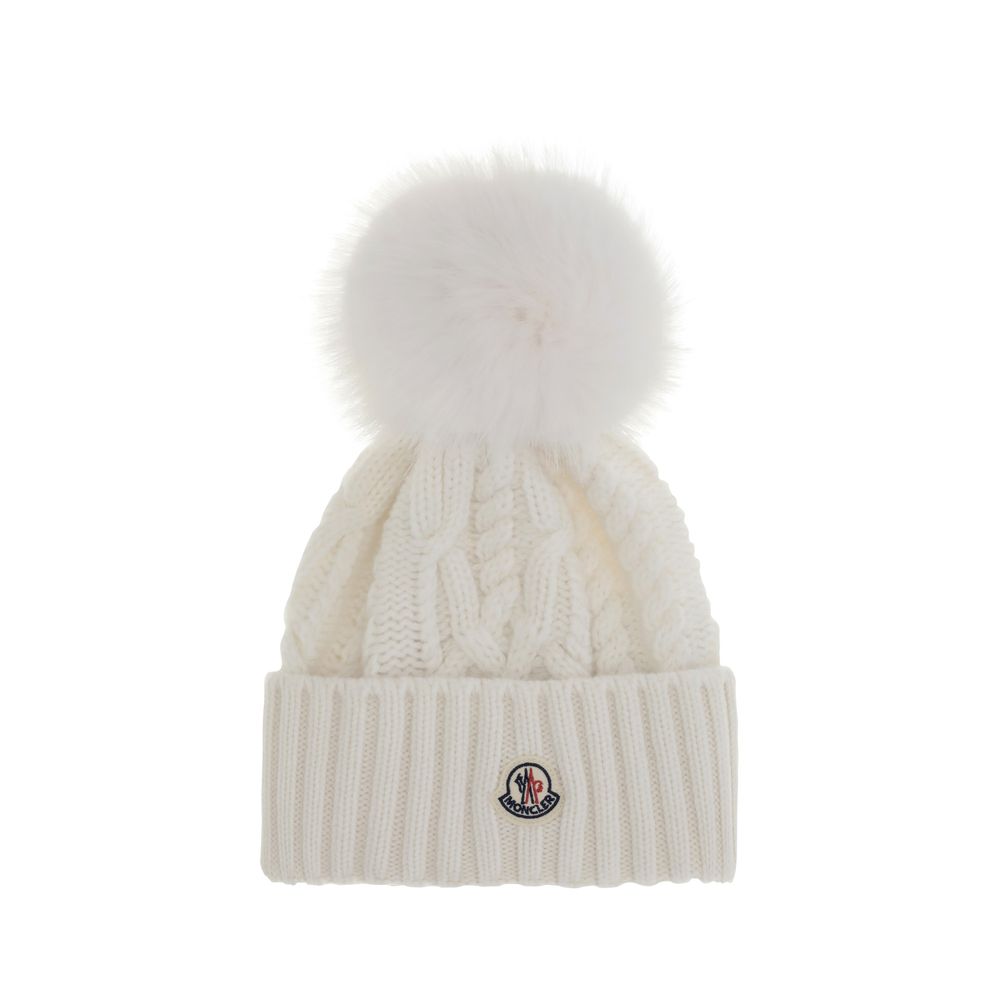 Cashmere blend Hat with pom-ponMoncler’s cashmere blend Hat combines softness and style in a stylish and functional accessory. Made from a Cable and Aran knit, it features a logo patch on the front that underscores its identity. Completing the design is t
