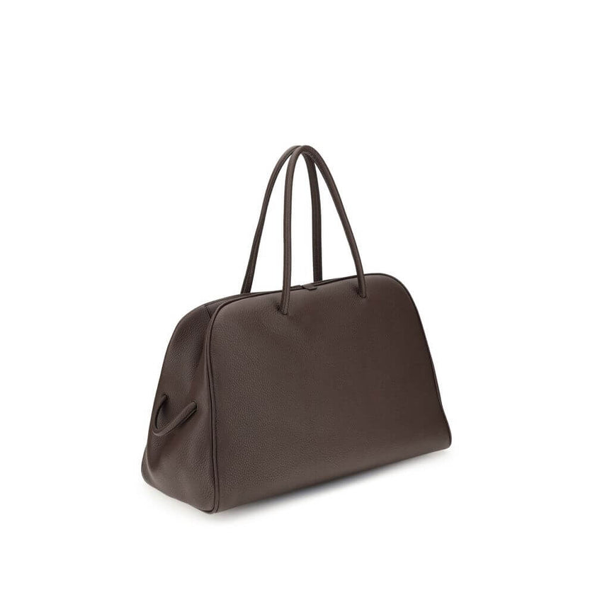 Brown Calf Leather Bos Taurus HandbagThe Le Grand Tourisme Travel Bag by Jacquemus reinterprets the classic bowling bag in a modern and sophisticated key. Made of grained leather, it features a structured and functional design with a two-way zipper closur