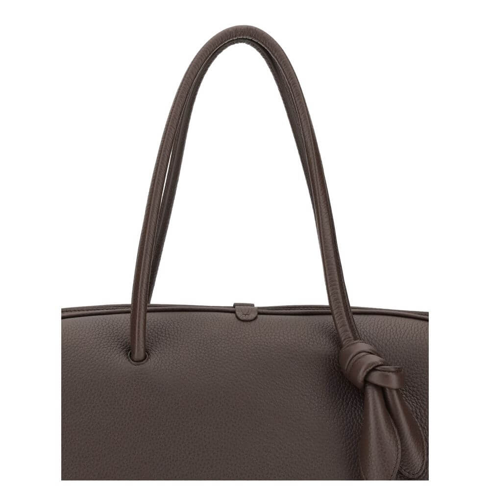 Brown Calf Leather Bos Taurus HandbagThe Le Grand Tourisme Travel Bag by Jacquemus reinterprets the classic bowling bag in a modern and sophisticated key. Made of grained leather, it features a structured and functional design with a two-way zipper closur