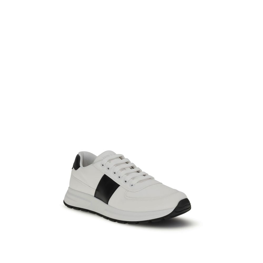 White Calf Leather Bos Taurus Low Top SneakersPrada’s leather Sneakers feature a two-tone design that combines elegance and contemporary style. Featuring a lace-up closure and reinforced toe for added durability, they are complemented by the logo on the b