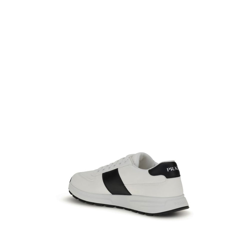 White Calf Leather Bos Taurus Low Top SneakersPrada’s leather Sneakers feature a two-tone design that combines elegance and contemporary style. Featuring a lace-up closure and reinforced toe for added durability, they are complemented by the logo on the b