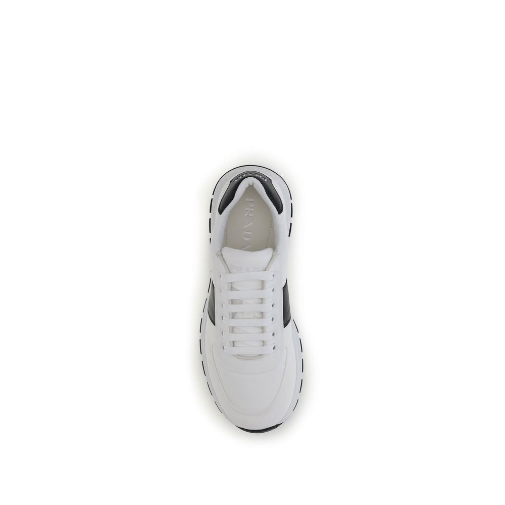 White Calf Leather Bos Taurus Low Top SneakersPrada’s leather Sneakers feature a two-tone design that combines elegance and contemporary style. Featuring a lace-up closure and reinforced toe for added durability, they are complemented by the logo on the b