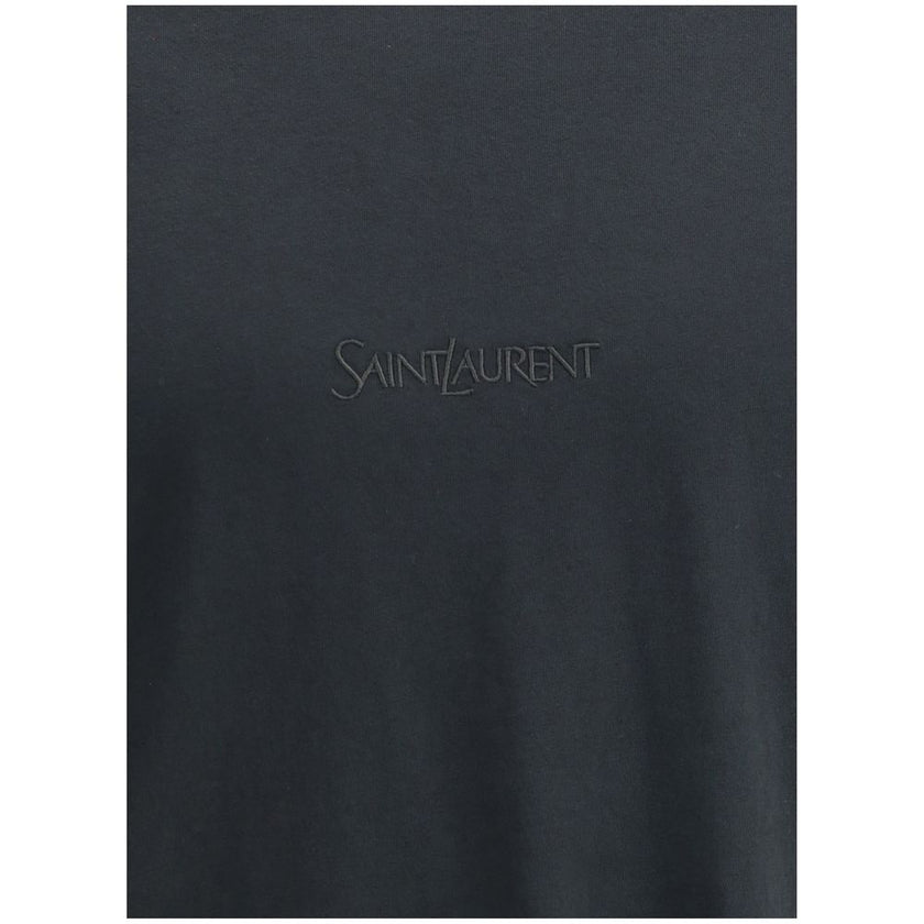 Black Cotton T-ShirtSaint Laurent’s cotton T-shirt is an essential and refined piece with a minimalist design. The ribbed crew neck ensures comfort, while the brand’s iconic tone-on-tone embroidered logo on the front adds a discreet yet distinctive touch