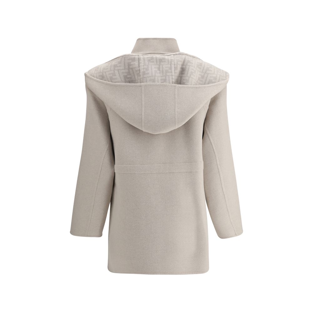 Cream Wool CoatFendi’s wool Coat is a stylish and versatile garment perfect for tackling the winter season in style. The removable hood and scarf add an extra touch of warmth and can be easily detached to fit different needs. The front zipper and button c