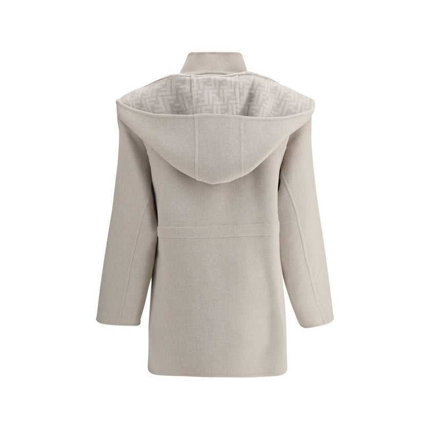 Cream Wool CoatFendi’s wool Coat is a stylish and versatile garment perfect for tackling the winter season in style. The removable hood and scarf add an extra touch of warmth and can be easily detached to fit different needs. The front zipper and button c