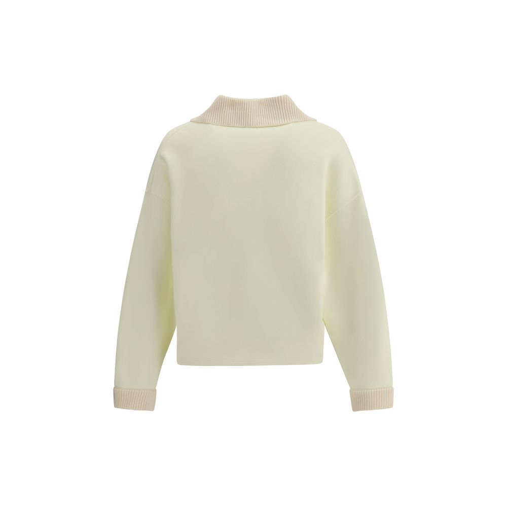 Cream Cotton SweatshirtThe polo Sweatshirt by Jacquemus is a garment that blends the elegance of the polo shirt with the relaxed spirit of the sweatshirt. Made of soft cotton, it is embellished with a ribbed wool collar and cuffs that add structure and a