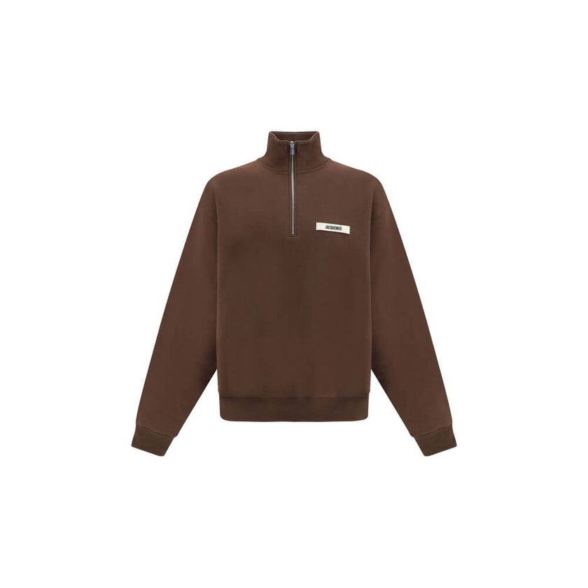 Brown Cotton SweatshirtThe cotton Le Camionneur Sweatshirt by Jacquemus features a plush interior for optimal comfort. The brand’s iconic monogram patch applied to the front adds a distinctive touch, while the ribbed cuffs and hem ensure a comfortable, fi