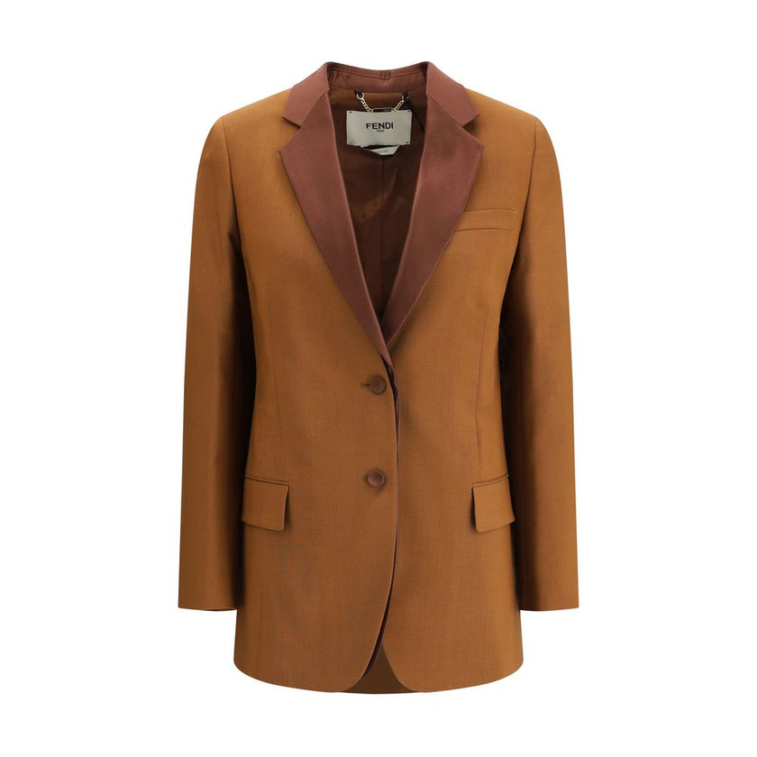 Brown Wool BlazerFendi’s wool and mohair Blazer is a timeless classic with a refined style, embellished with satin lapels that enhance its elegance. It features a single-breasted button closure, a breast pocket and two front flap pockets. Three decorative