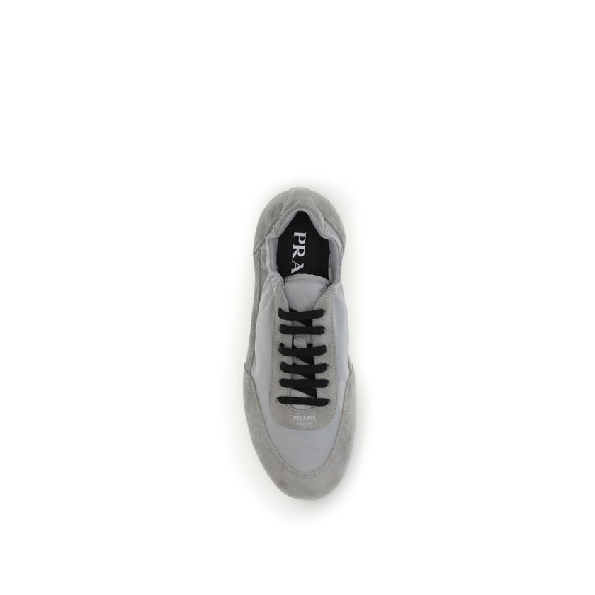 Gray Rubber Athletic SneakersPrada’s Sneakers feature a round toe and suede details, with front lace-up closure for a comfortable fit. The brand’s iconic monogram can be seen in contrast on the front, while the elasticized ankle lap ensures added comfort.