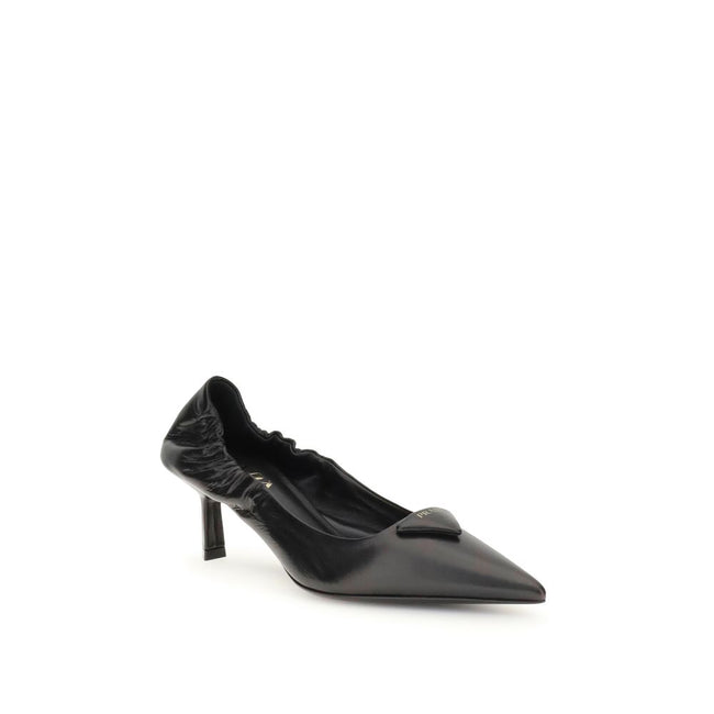 Black Calf Leather Bos Taurus High Heel PumpsPrada’s logo Pumps are made of leather and feature a soft, tapered silhouette. The pointed toe model features a deconstructed design, enhanced by an elastic back that ensures comfort and fit. The architectural