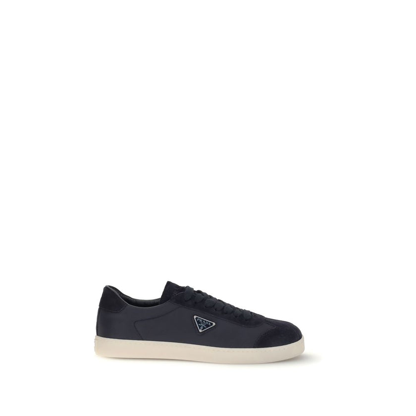 Blue Leather SneakersLeather Sneakers by Prada combine contemporary style with everyday comfort. Featuring a flat rubber sole and round toe, they are distinguished by the iconic triangular side-applied plaque and tone-on-tone logo on the back, adding a di