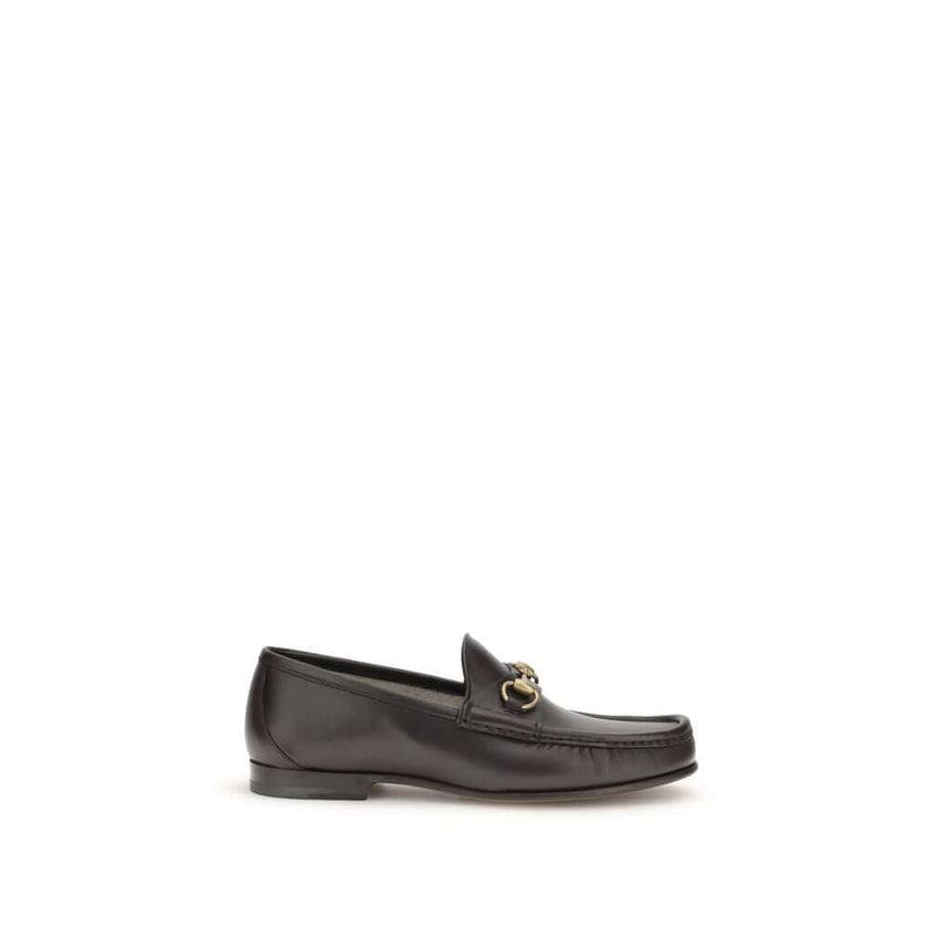 Brown Calf Leather Bos Taurus Slip-On Loafers1953 Horsebit Loafers by Gucci celebrate the house’s timeless elegance with a classic and iconic design. Crafted in dark brown leather, they are embellished with the Horsebit detail with gold-tone hardware. Par