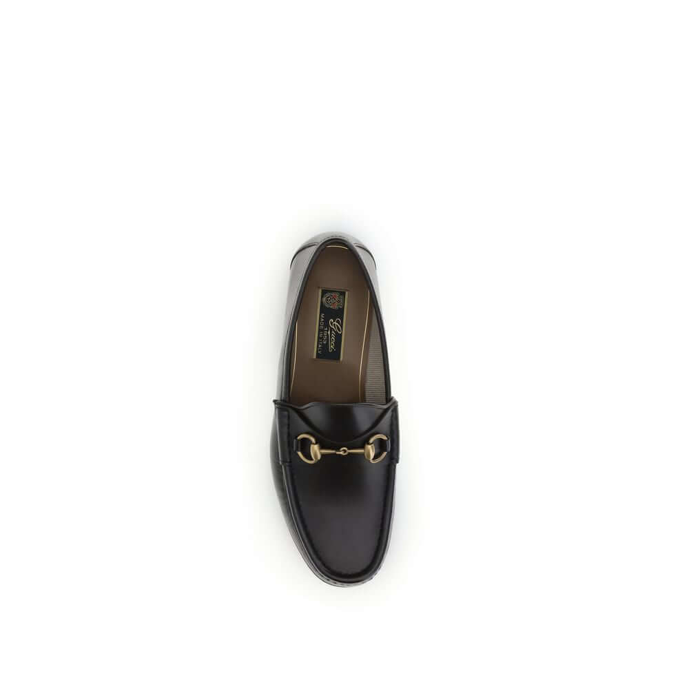 Brown Calf Leather Bos Taurus Slip-On Loafers1953 Horsebit Loafers by Gucci celebrate the house’s timeless elegance with a classic and iconic design. Crafted in dark brown leather, they are embellished with the Horsebit detail with gold-tone hardware. Par