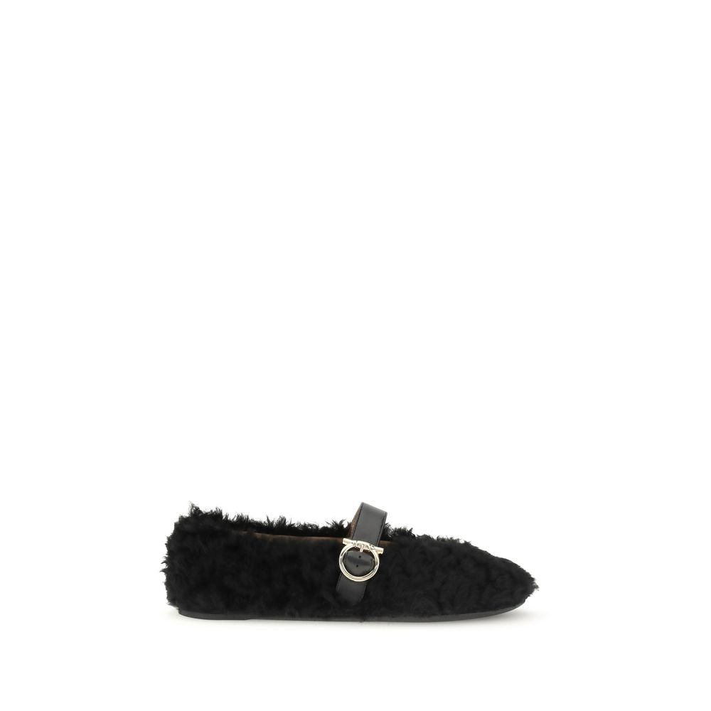 Black Fur Ballet FlatsFerragamo’s Gancini-embellished Ballerinas by Ferragamo reinterprets a classic with a playful, contemporary twist. Featuring a contoured neckline and soft silhouette, it is distinguished by a curly shearling lining, ideal for the col