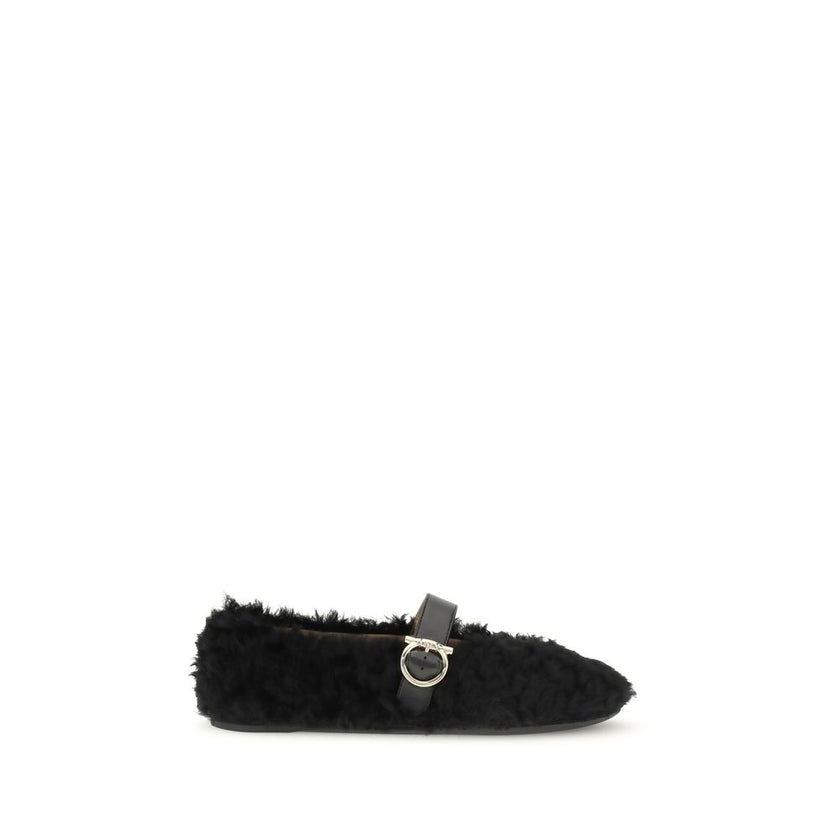 Black Fur Ballet FlatsFerragamo’s Gancini-embellished Ballerinas by Ferragamo reinterprets a classic with a playful, contemporary twist. Featuring a contoured neckline and soft silhouette, it is distinguished by a curly shearling lining, ideal for the col