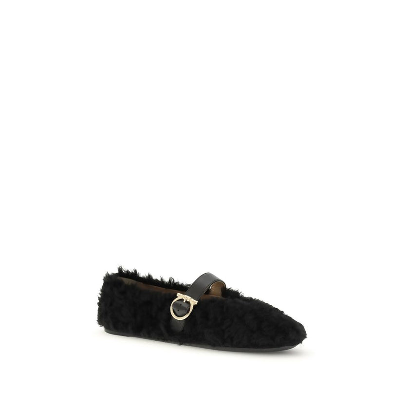 Black Fur Ballet FlatsFerragamo’s Gancini-embellished Ballerinas by Ferragamo reinterprets a classic with a playful, contemporary twist. Featuring a contoured neckline and soft silhouette, it is distinguished by a curly shearling lining, ideal for the col