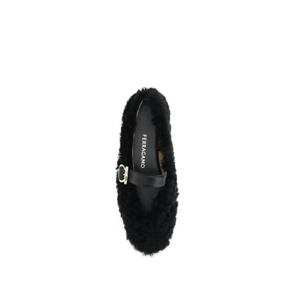 Black Fur Ballet FlatsFerragamo’s Gancini-embellished Ballerinas by Ferragamo reinterprets a classic with a playful, contemporary twist. Featuring a contoured neckline and soft silhouette, it is distinguished by a curly shearling lining, ideal for the col