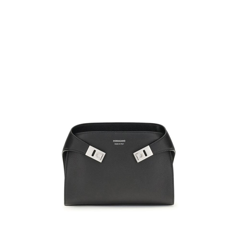 Leather Hug Fanny PackThe leather Hug Fanny Pack by Ferragamo reinterprets the iconic shapes of the collection in a compact and elegant version. Made of fine leather, it opens with a bridge and double magnet, revealing an interior also lined in leather. V